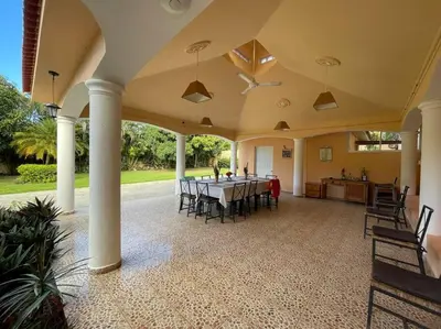 a large patio with a table and chairs at Luxury Villa Classic style, 7 minutes from the beach in Sosua in San Felipe de Puerto Plata