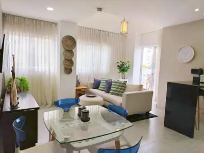 a living room with a couch and a glass table at Refa 304 in Santo Domingo