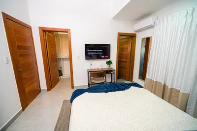 a bedroom with a bed and a television in it at Refa 304 in Santo Domingo