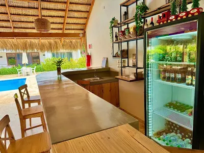 a bar in a kitchen with a refrigerator at La Curadiña - Encuentro Surf Resort in Cabarete
