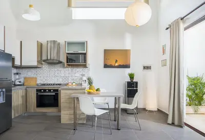 a kitchen with a table and chairs in a room at La Curadiña - Encuentro Surf Resort in Cabarete