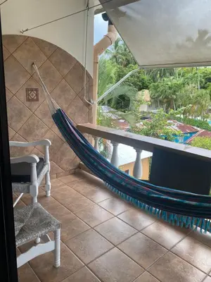 a hammock in a room with a view at Cita del Sol City Apartments in Cabarete