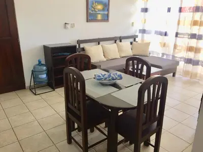 a living room with a table and a couch at Cita del Sol City Apartments in Cabarete