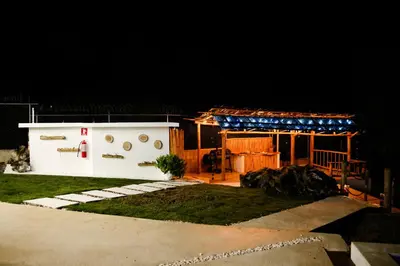 a house with a garage at night at Hotel Don Bululo Camping Lodge in Punta Rucia
