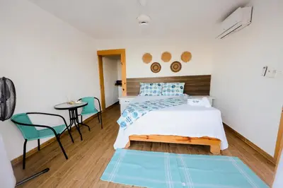 a bedroom with a bed and a table and chairs at Hotel Don Bululo Camping Lodge in Punta Rucia