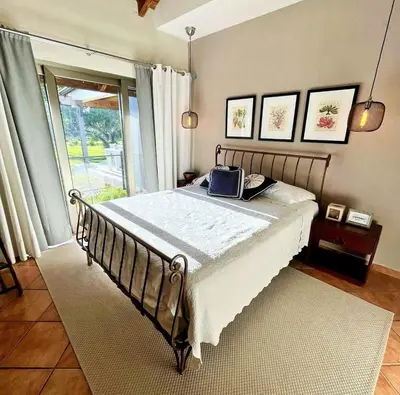 a bedroom with a bed in a room with a window at Villa Mariposa in Cajuiles