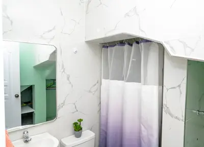 a bathroom with a shower curtain and a sink at Apartamento moderno de una habitación in San Pedro de Macorís