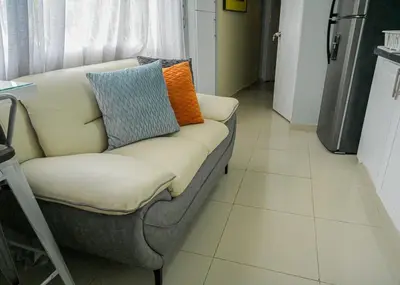 a couch with pillows on it in a kitchen at Suite in San Pedro De Macoris in San Pedro de Macorís