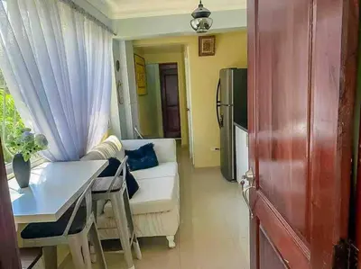 a living room with a white couch and a table at Suite in San Pedro De Macoris in San Pedro de Macorís