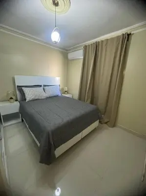 a small bedroom with a bed and a window at Oasis en la Sultana del Este in San Pedro de Macorís