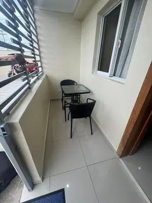 a room with two chairs and a table and a window at Apartamento de Lujo En San Pedro in San Pedro de Macorís