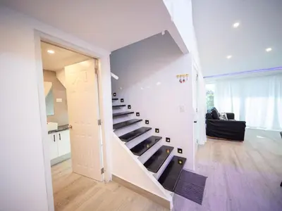 a staircase in a living room with a stair case at 3BR Luxury Penthouse, 300m From Beach in Sosúa
