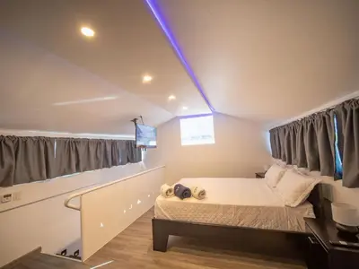 a small bedroom with a bed and a window at 3BR Luxury Penthouse, 300m From Beach in Sosúa