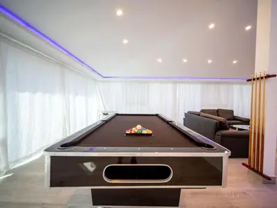 a living room with a pool table in it at 3BR Luxury Penthouse, 300m From Beach in Sosúa