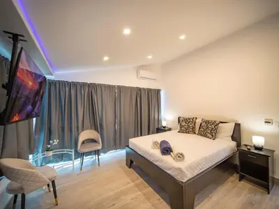 a bedroom with a bed and a large window at 3BR Luxury Penthouse, 300m From Beach in Sosúa