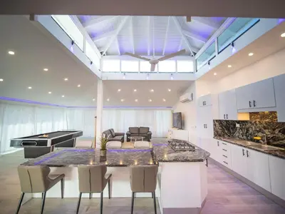 a kitchen with a large island in a room at 3BR Luxury Penthouse, 300m From Beach in Sosúa