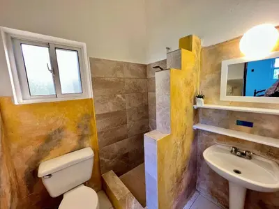 a bathroom with a toilet and a sink at Casati Pearl House, Big House With Private Pool in Bombita