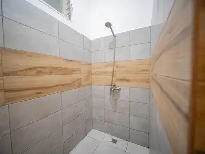 a bathroom with a shower and a toilet in it at Plaza Achim 6b, Modern Apt 250m From Sosua Beach in Sosúa