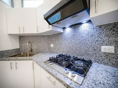 a kitchen with a stove and a counter top at Cozy 1 Bedroom Apartment in Heart of Sosa in Sosúa
