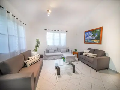 a living room with two couches and a table at Casati Family House, Great Pool Garden in Sosúa