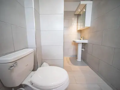 a bathroom with a white toilet and a sink at 2BR Luxury Apartment in Heart Of Nightlife Area in Sosúa