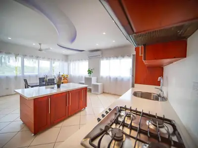 a kitchen with a stove and a counter top at 2BR Luxury Apartment in Heart Of Nightlife Area in Sosúa