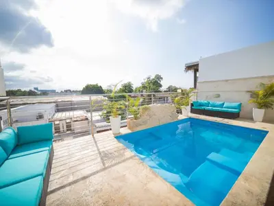 a swimming pool on the roof of a building at 4br Penthouse With Rooftop Pool In Sosua Strip in Sosúa