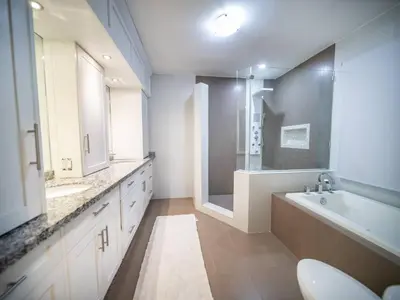 a bathroom with a tub and a sink and a toilet at 4br Penthouse With Rooftop Pool In Sosua Strip in Sosúa