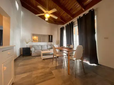 a living room with a table and a couch at Vittoria's House 402 in Bayahibe