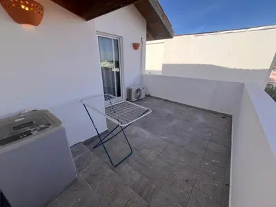 a balcony with a table and a washing machine at Vittoria's House 402 in Bayahibe