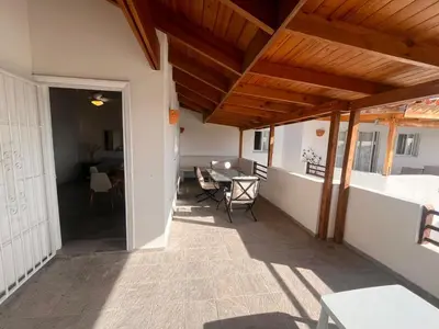 a balcony of a house with a table and chairs at Vittoria's House 402 in Bayahibe