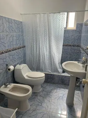 a bathroom with a toilet and a sink at Playa Azul House in Bayahibe