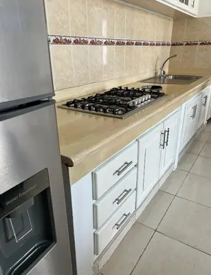 a kitchen with a stove top oven next to a sink at Playa Azul House in Bayahibe
