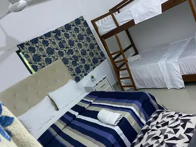a bedroom with two beds and a ladder at Apartamento JGB 2 in Sosúa