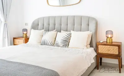 a bedroom with a large bed with two night stands at Estrella Dominicus deluxe Apartment in La Laguna