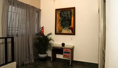 a room with a table and a painting on the wall at Hotelito Bonito Eli & Edw in Santo Domingo