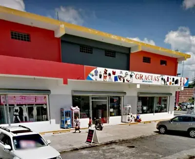 a building with cars parked in front of it at Cozy & Spacious Apartament Boca Chica Beach in Boca Chica