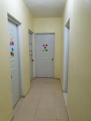 a hallway with two white doors and a tile floor at Villa Privada con Piscina a Minutos del Aeropuerto de Santo Domingo in Boca Chica