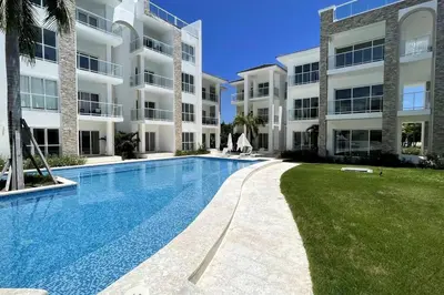 a swimming pool in front of a apartment building at Caribbean Retreat at Cana Bay Golf Residence in Punta Cana