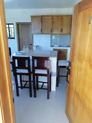 a kitchen with a table and chairs in a room at Apartamentos JGB in Sosúa Abajo