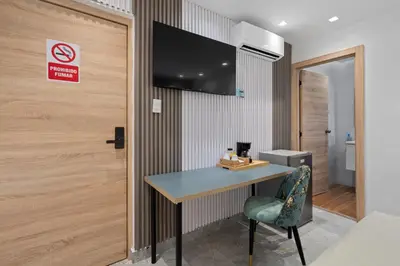 a room with a table and a sign on a wall at Hotel Vista Caribe Azúa in Azua de Compostela