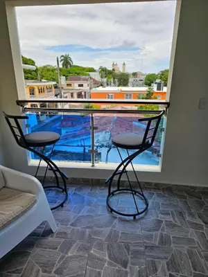 a room with two chairs and a large window at hermoso apartamento céntrico in San Felipe de Puerto Plata