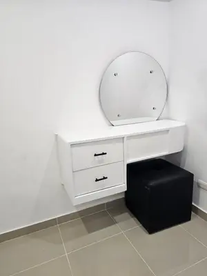 a white vanity with a mirror and a black stool at hermoso apartamento céntrico in San Felipe de Puerto Plata
