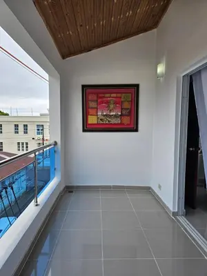 a large balcony with white walls and a wooden ceiling at hermoso apartamento céntrico in San Felipe de Puerto Plata