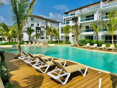 a swimming pool with lounge chairs and a hotel at Beautiful Star of the Caribbean - Apartment Estrella Dominicus Bayahibe in La Laguna