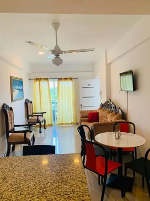 a living room with a couch and a table and chairs at Plataview Apartahotel apt 3A in Monte Plata