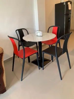 a table and four chairs and a refrigerator at Plataview Apartahotel apt 3A in Monte Plata