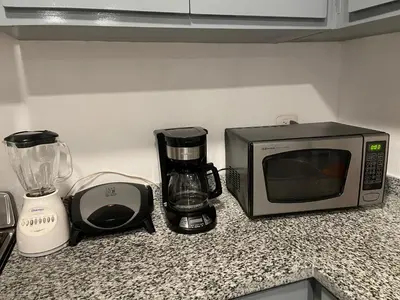 a kitchen counter with a microwave and a blender at Plataview Apartahotel apt 3A in Monte Plata
