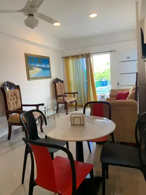 a living room with a table and chairs at Plataview Apartahotel apt 3A in Monte Plata