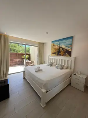 a bedroom with a large bed and a large window at Blue Coast Apartment - Vibe Dominicus in La Laguna
